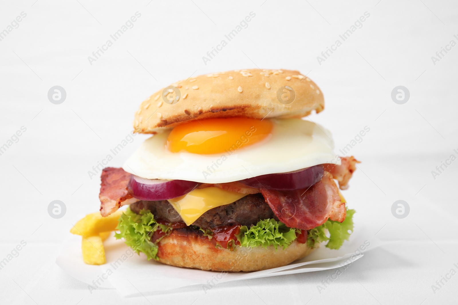 Photo of Delicious burger with fried egg on white table, closeup