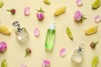 Photo of Flat lay composition with elegant perfumes on beige background