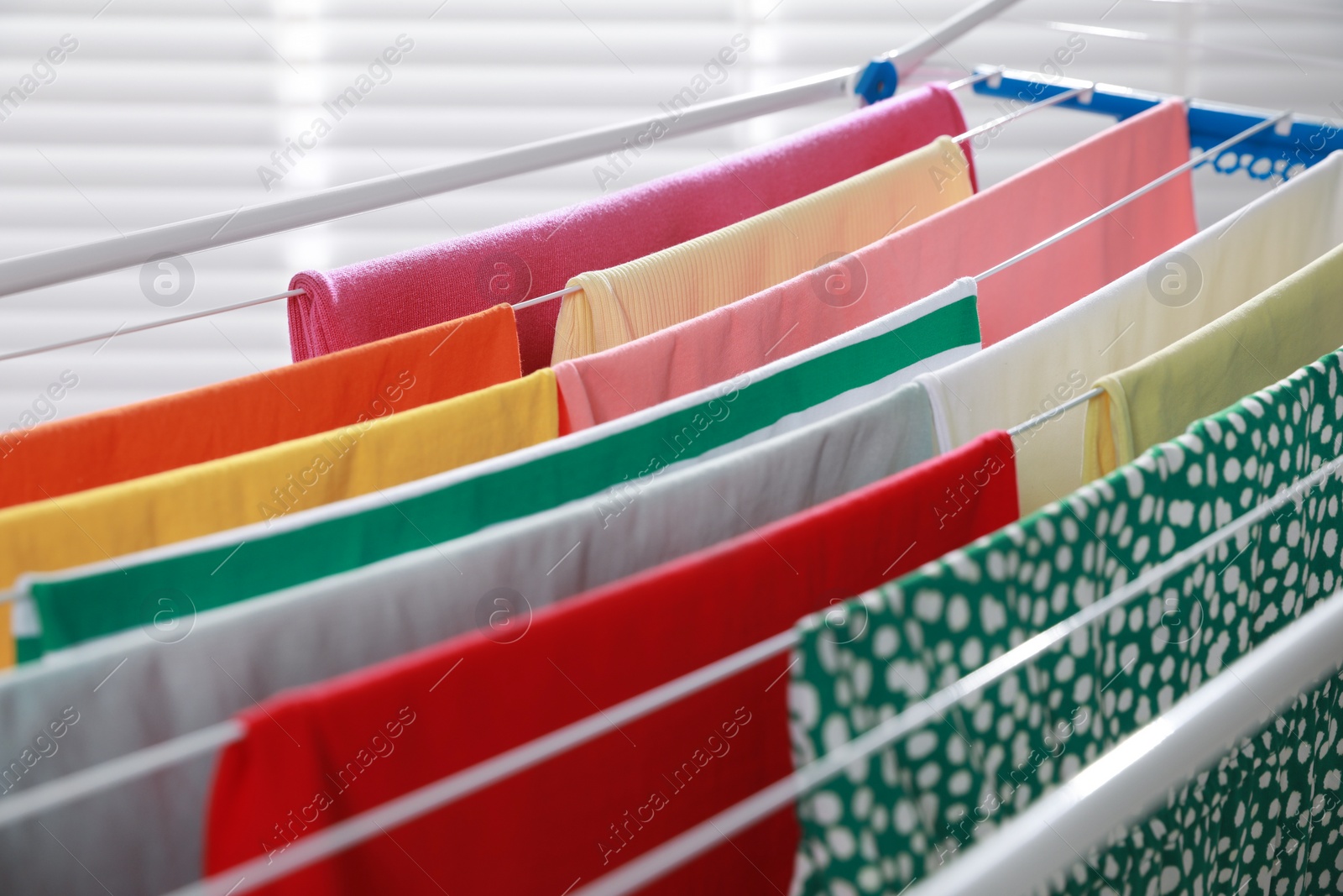 Photo of Different apparel drying on clothes airer, closeup