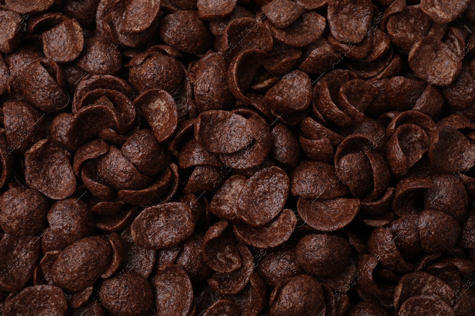 Photo of Breakfast cereal. Tasty chocolate corn flakes as background, top view