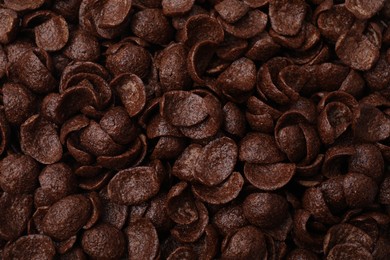 Photo of Breakfast cereal. Tasty chocolate corn flakes as background, top view