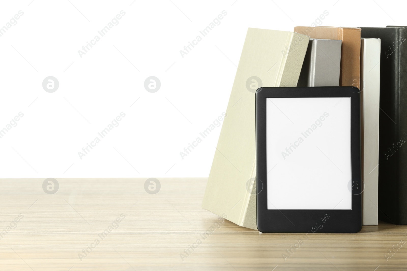 Photo of Hardcover books and modern e-book on wooden table against white background. Space for text