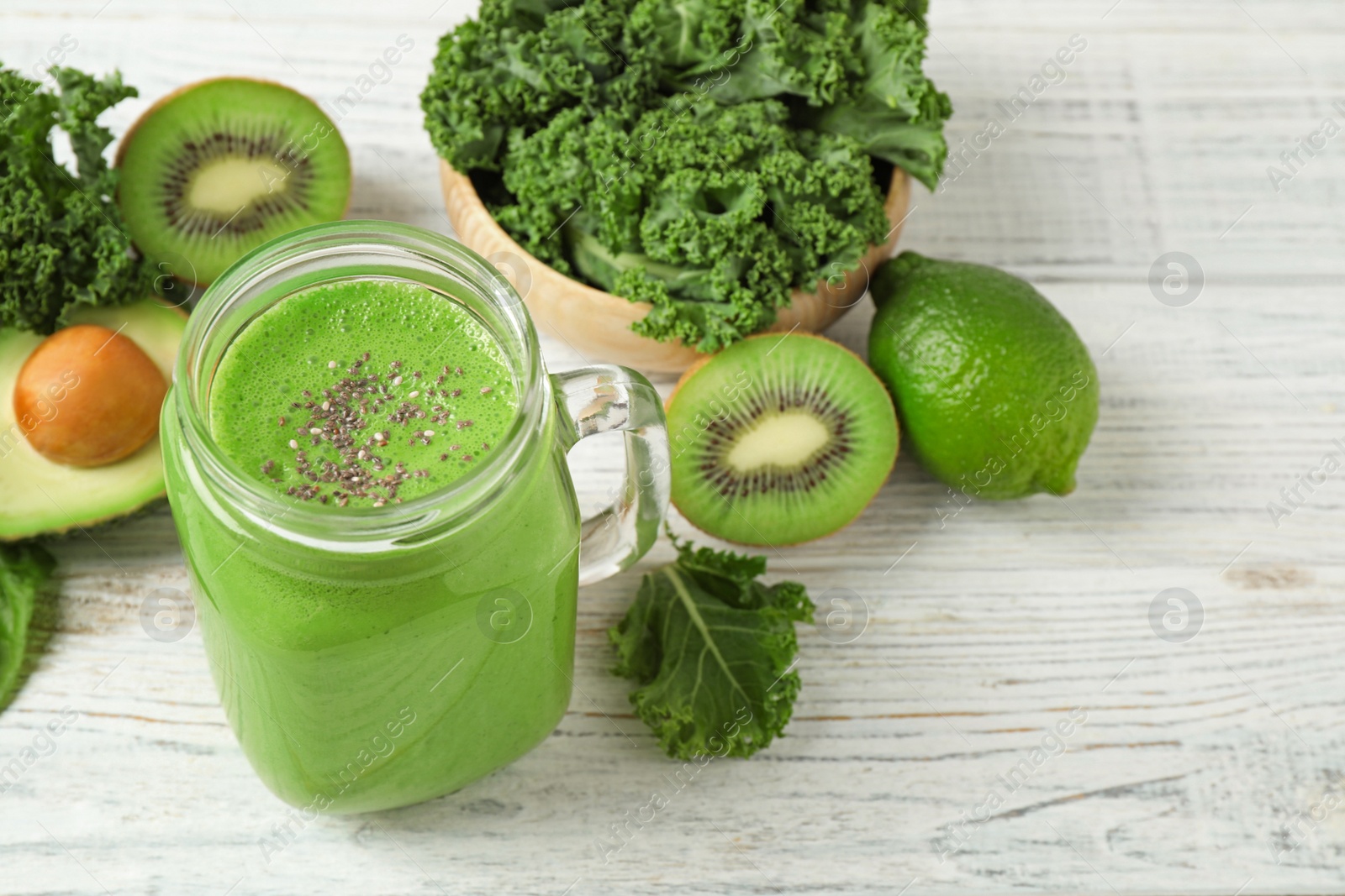 Photo of Tasty fresh kale smoothie on white wooden table