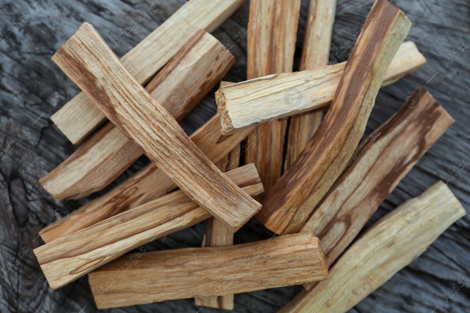 Photo of Palo santo sticks on wooden table, top view