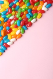 Photo of Flat lay composition with delicious jelly beans on light background. Space for text