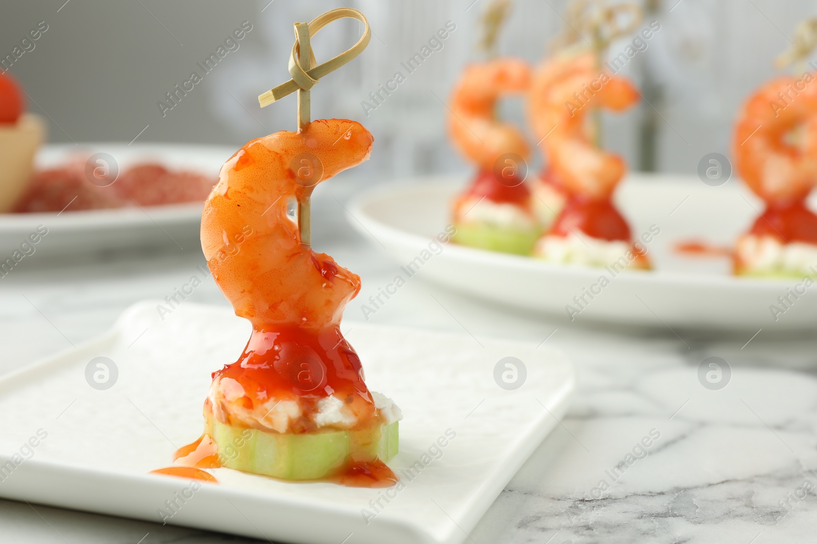 Photo of Tasty canape with shrimp, vegetables and cream cheese on white marble table, closeup. Space for text