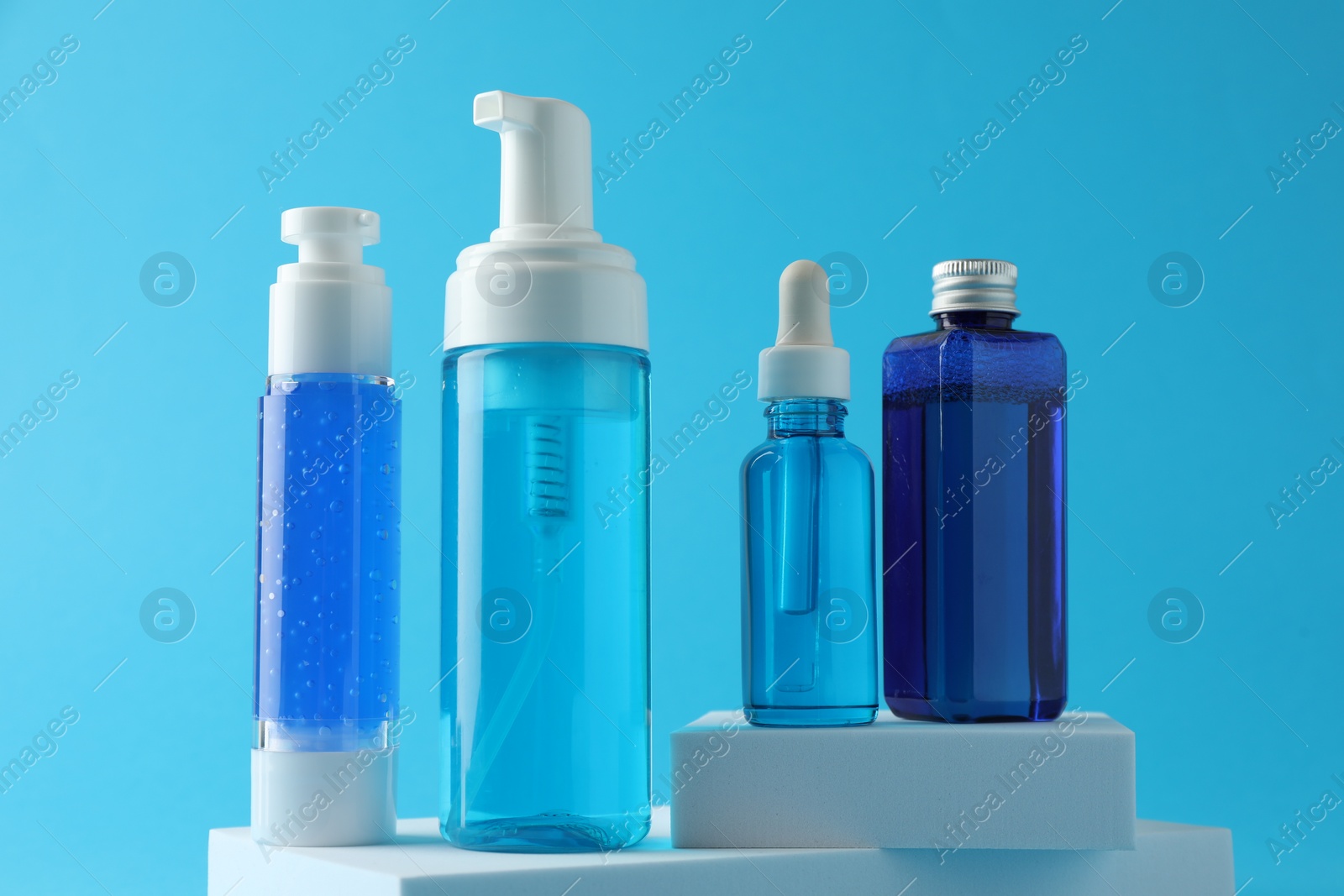 Photo of Set of luxury cosmetic products on light blue background