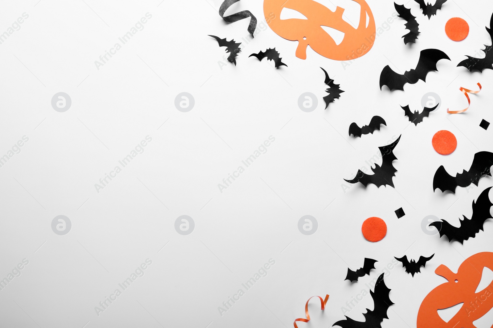 Photo of Halloween decor elements on white background, flat lay. Space for text