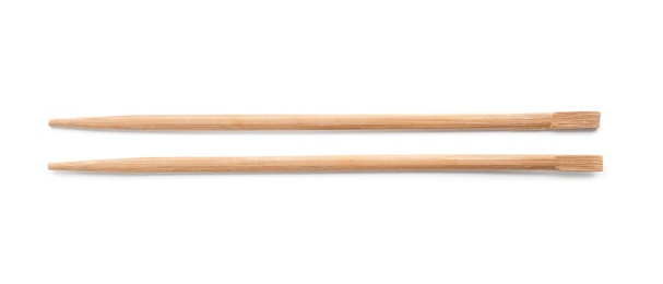 Photo of Chopsticks made of bamboo on white background, top view