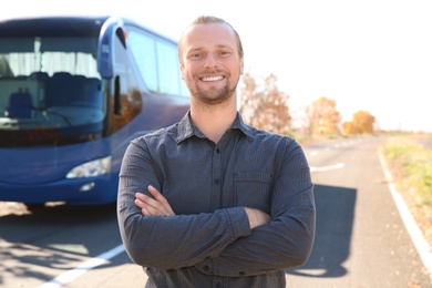 Photo of Professional driver standing near bus. Passenger transportation