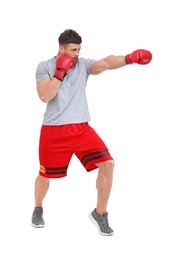 Photo of Man in boxing gloves fighting on white background