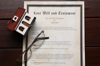 Photo of Last Will and Testament, house model and glasses on wooden table, flat lay