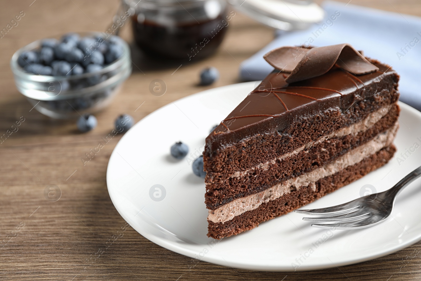 Photo of Delicious fresh chocolate cake served on wooden table