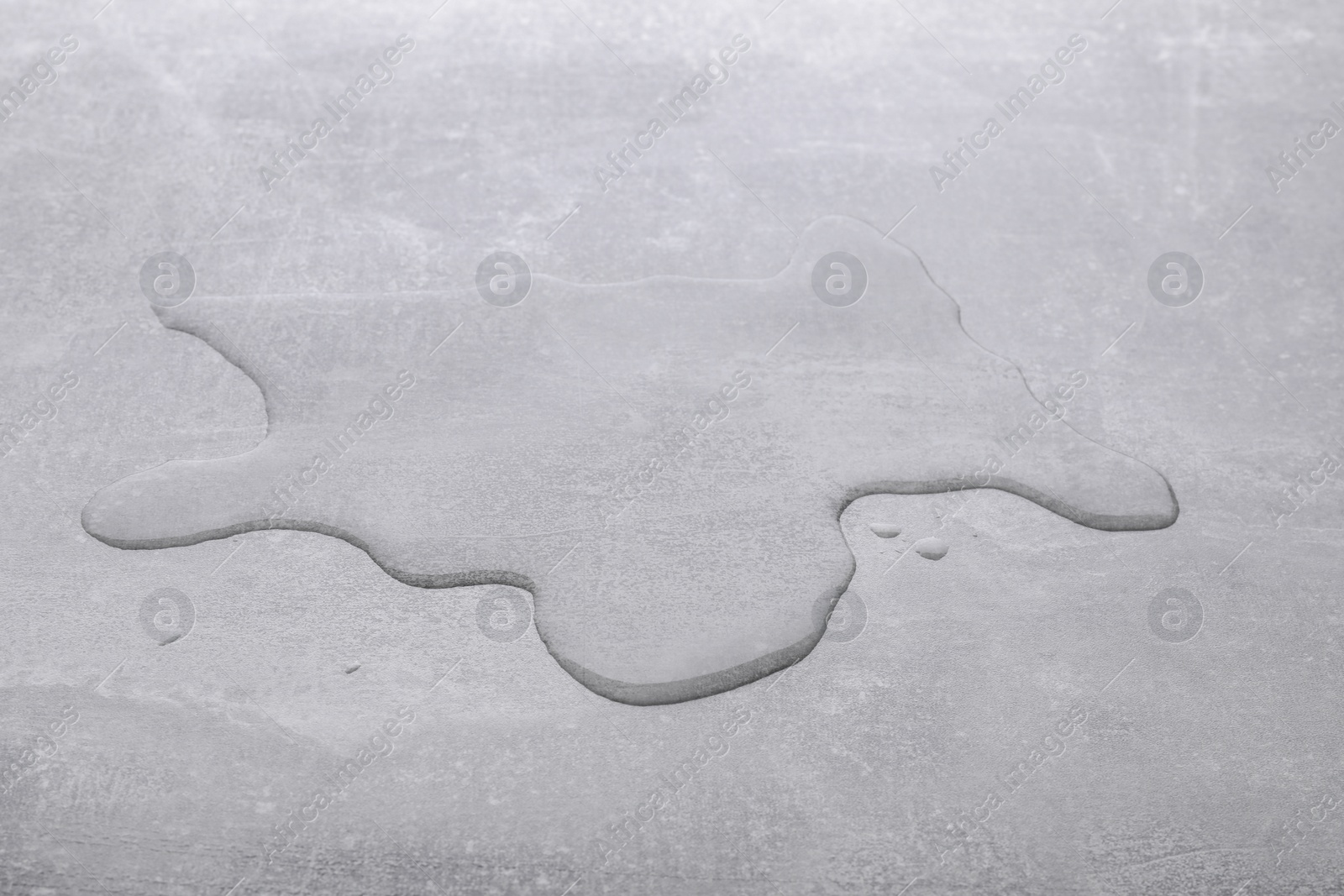 Photo of Puddle of water on light grey surface