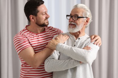 Happy son and his dad at home