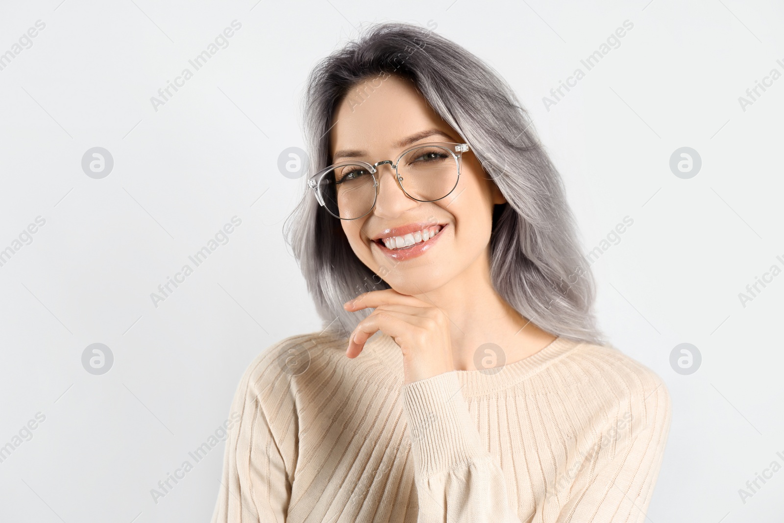 Image of Portrait of smiling woman with ash hair color on light background