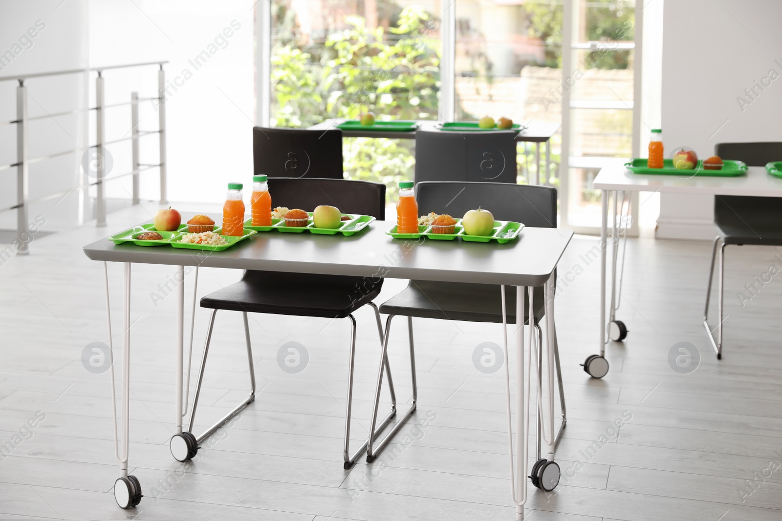 Photo of Trays with healthy food on table in school canteen