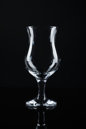 Photo of Clean empty cocktail glass on black background