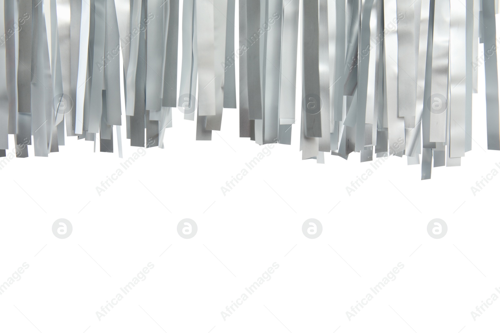 Photo of Shiny silver tinsel on white background, closeup