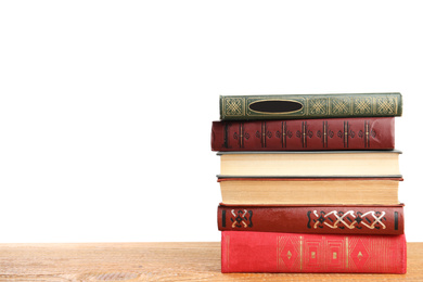 Photo of Stack of old vintage books on wooden table against white background