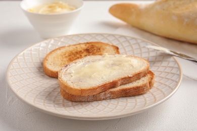 Photo of Tasty bread with butter for breakfast on plate