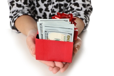 Photo of Woman holding gift box with dollar banknotes on white background, closeup