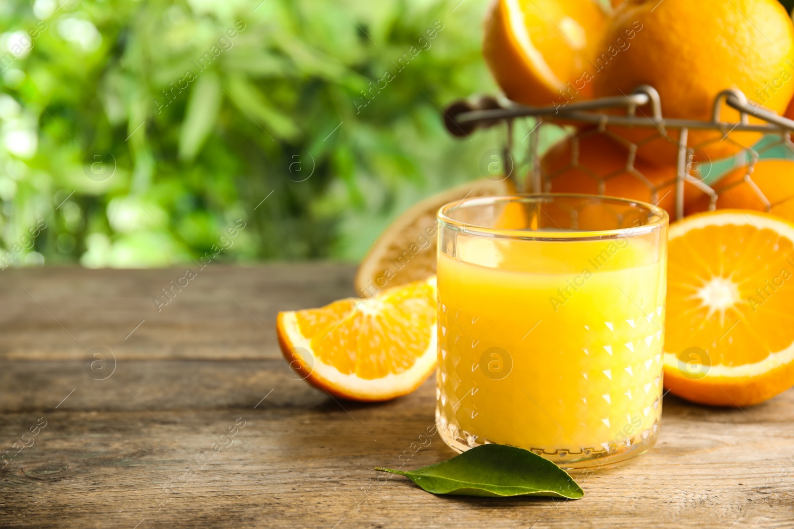 Photo of Composition with orange juice and fresh fruit on table, space for text