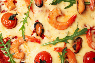 Delicious seafood pizza as background, top view