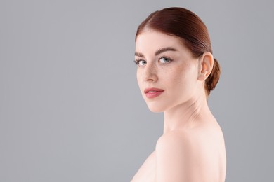 Photo of Portrait of beautiful woman on grey background. Space for text