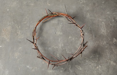 Photo of Crown of thorns on grey background, top view. Easter attribute