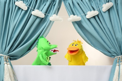 Photo of Creative puppet show on white stage indoors