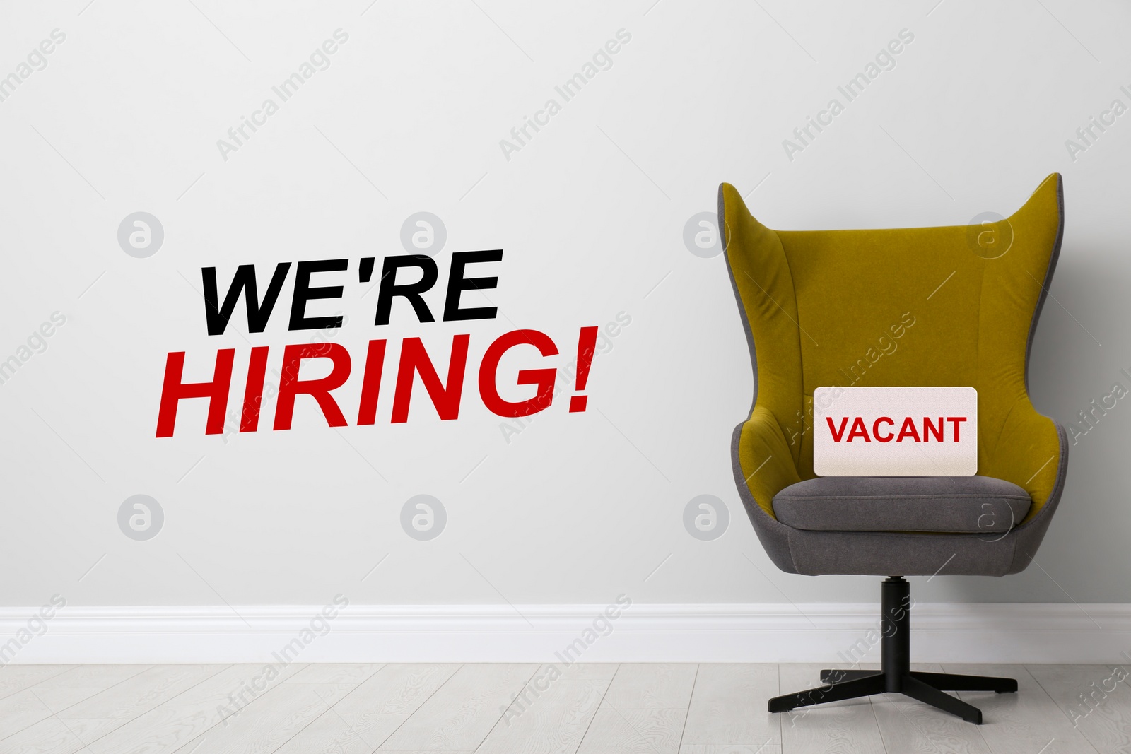 Image of We`re hiring! Comfortable office chair with sign VACANT near light wall indoors