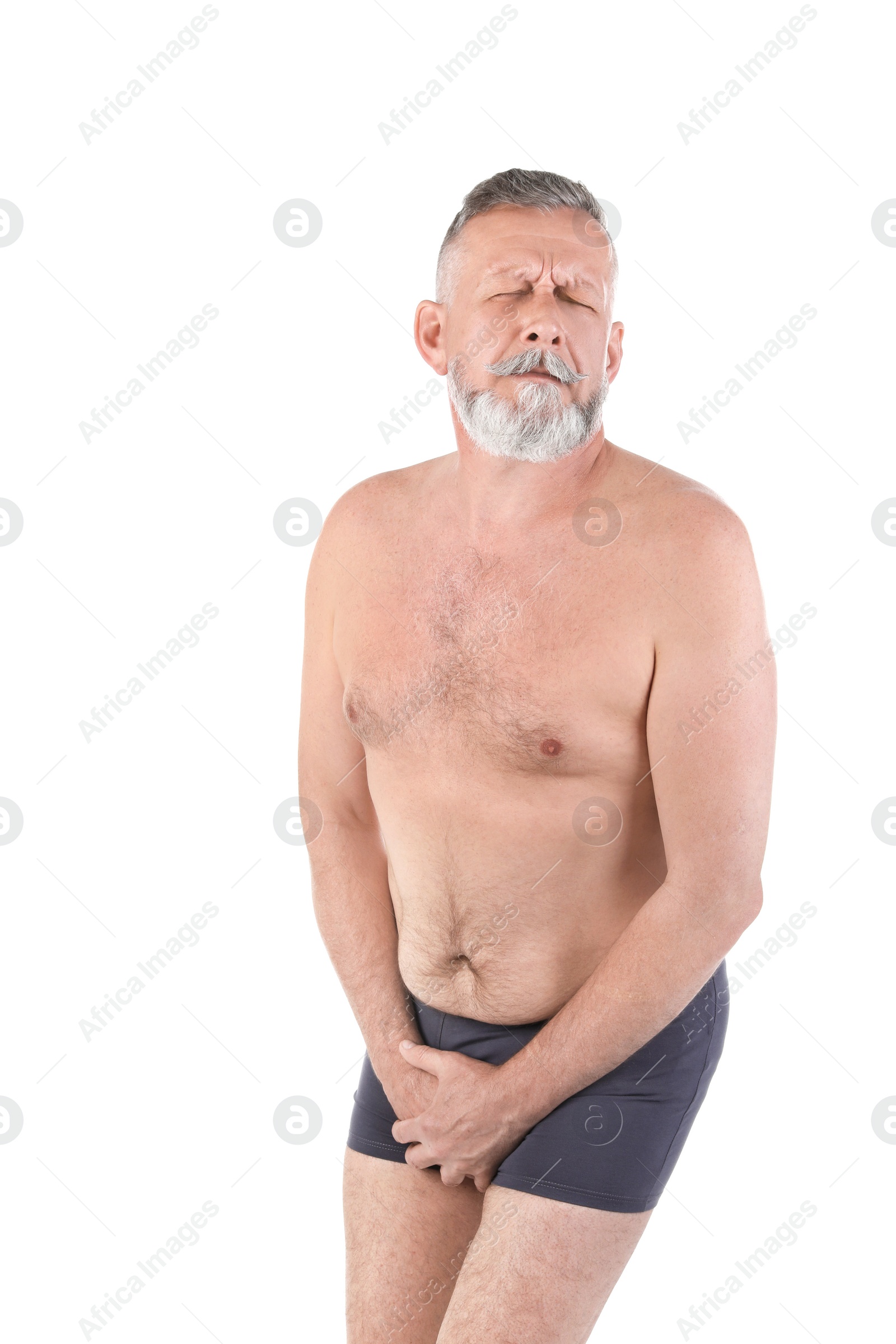 Photo of Mature man with urological problems suffering from pain on white background