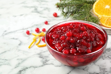 Photo of Cranberry sauce on white marble table, space for text
