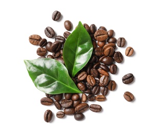 Photo of Roasted coffee beans and green leaves on white background, top view