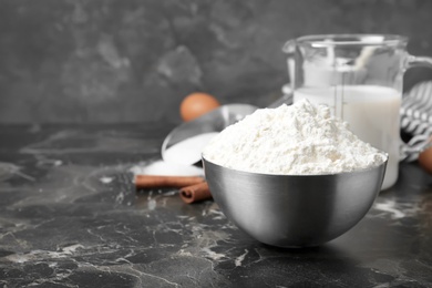 Photo of Bowl with flour on table