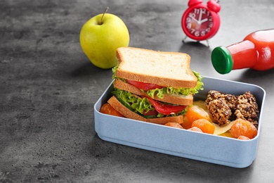 Photo of Lunch box with appetizing food on grey background
