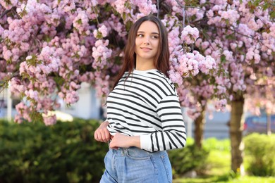 Photo of Beautiful woman near blossoming tree on spring day