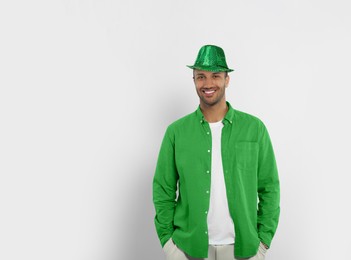Image of St. Patrick's day party. Man with green leprechaun hat on light background. Space for text