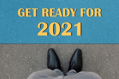 Image of Text Get Ready For 2021 on asphalt in front of man, top view