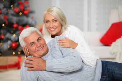 Photo of Happy mature couple at home. Christmas celebration