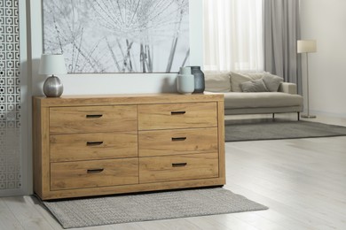 Photo of Cozy room interior with chest of drawers, painting, sofa and decor elements, space for text