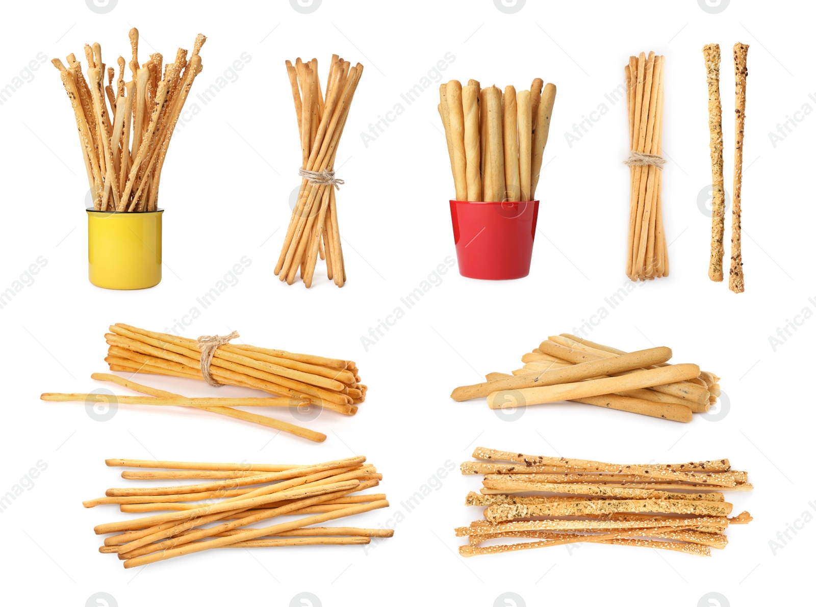 Image of Set with delicious crispy grissini sticks on white background