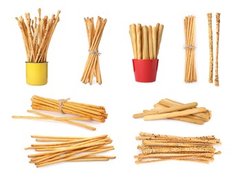 Image of Set with delicious crispy grissini sticks on white background