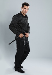 Photo of Male security guard in uniform on grey background