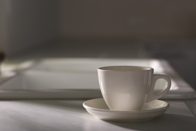 Photo of Cup of delicious coffee on table, space for text. Good morning