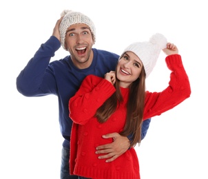 Photo of Happy young couple in warm clothes on white background. Winter season