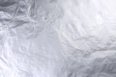 Photo of Shiny silver foil as background, top view