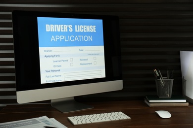 Photo of Computer with driver's license application form on table in office