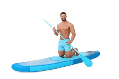Photo of Happy man with paddle on blue SUP board against white background
